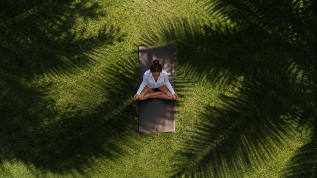 A woman meditating outdoors